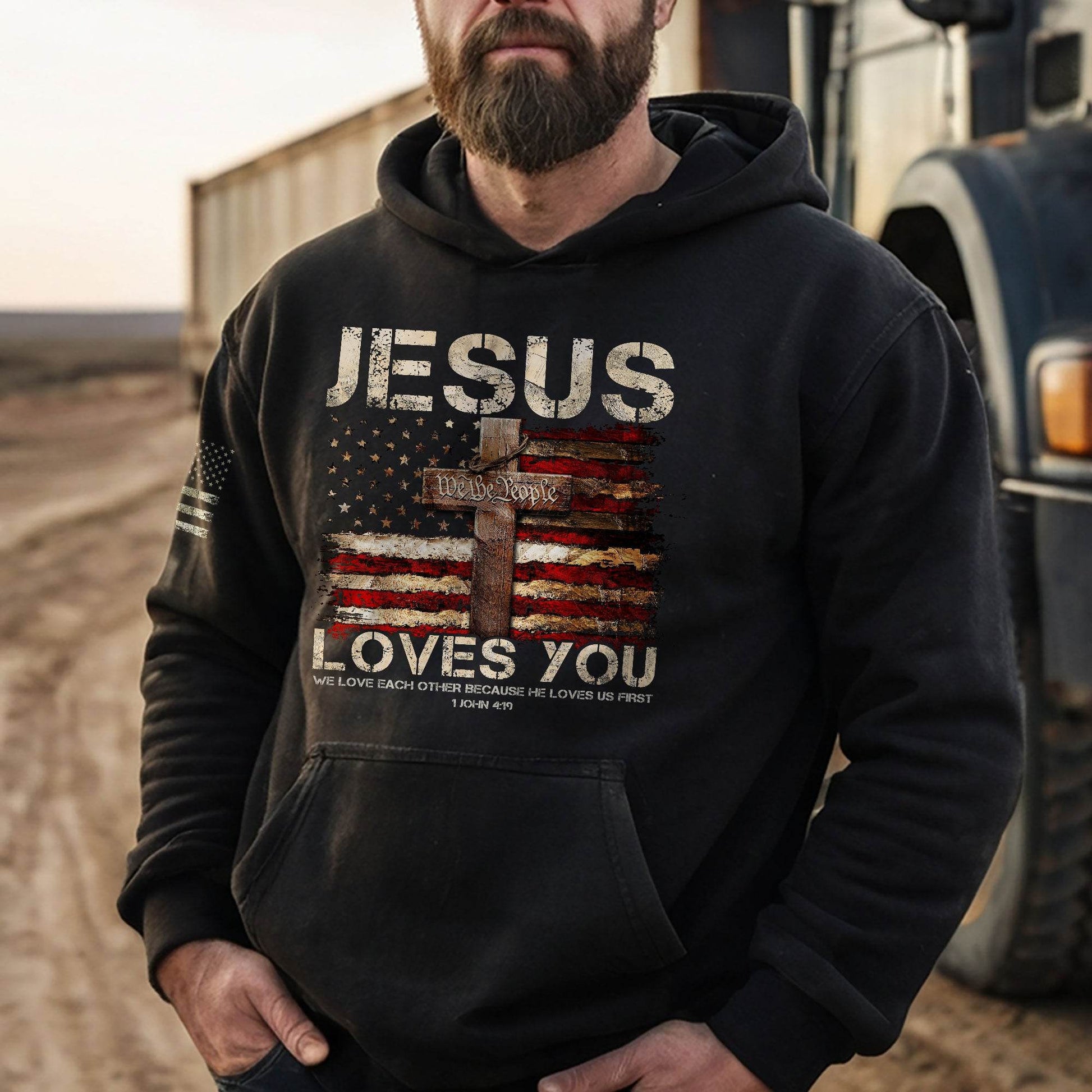 Jesus Loves You Hoodie – 1 John 4:19 Cross & We The People Flag - Rust Field Wear