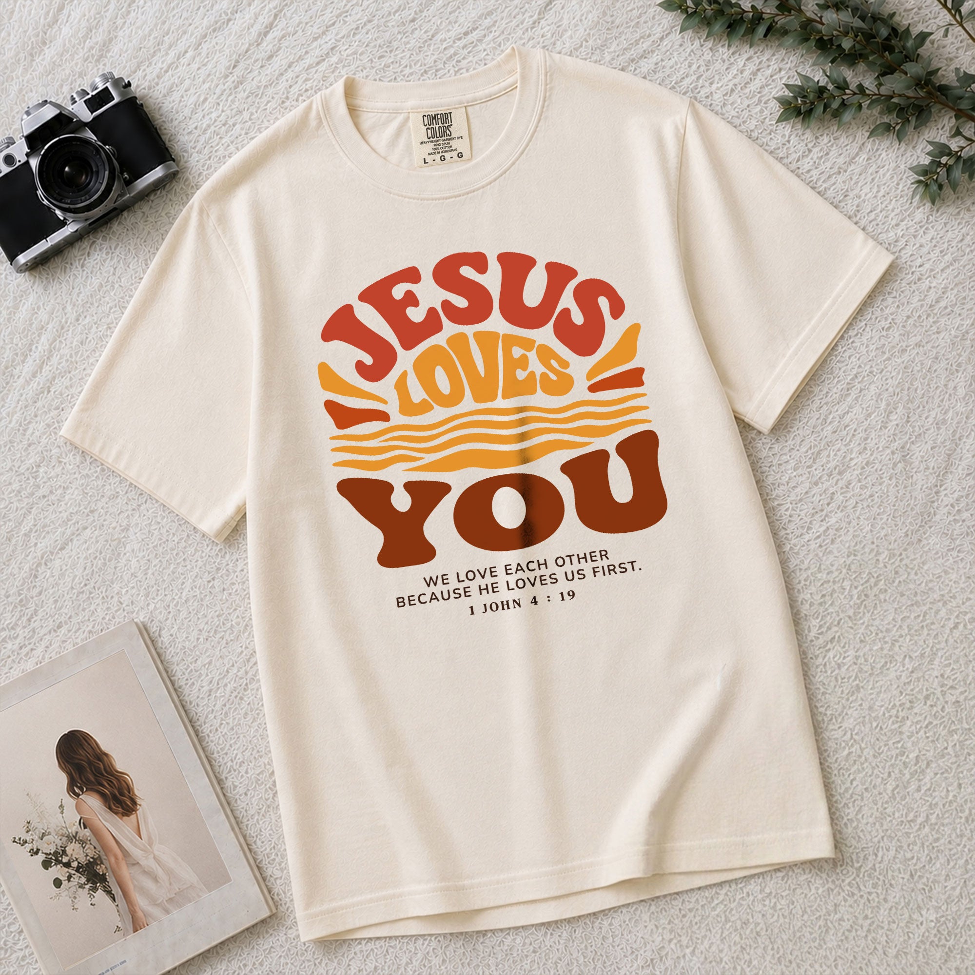 Jesus Loves You Shirt Sunset Wavy 70s Christian Bible Verse 1 John 4 19 Graphic Tee - Rust Field Wear