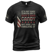 Its Not Easy Being My Wifes Arm Candy But Here I Am Nailing It USA Flag Graphic T-Shirt